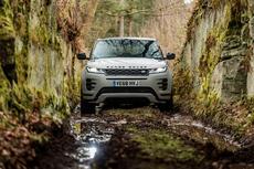 Silver Range Rover Evoque SUV drives through muddy tunnel Silver Range Rover Evoque SUV drives through muddy tunnel