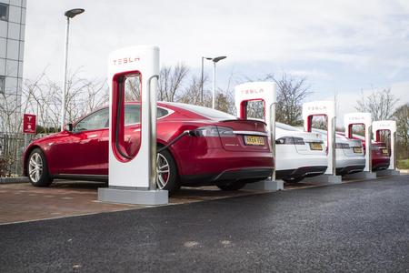 Tesla Charging Station Red Tesla at a dedicated charging station