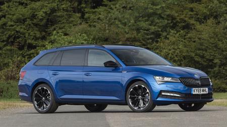 Skoda Superb Blue Skoda Superb driving through woodland