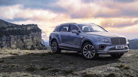 Bentley Bentayga Bentley Bentayga parked in front of sunset