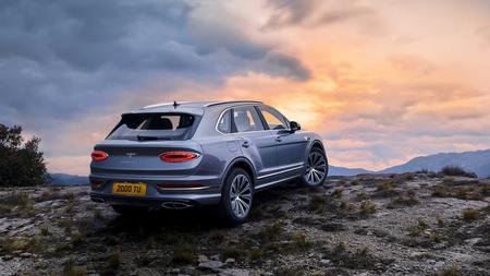 Bentley Bentayga Bentley Bentayga parked in front of sunset