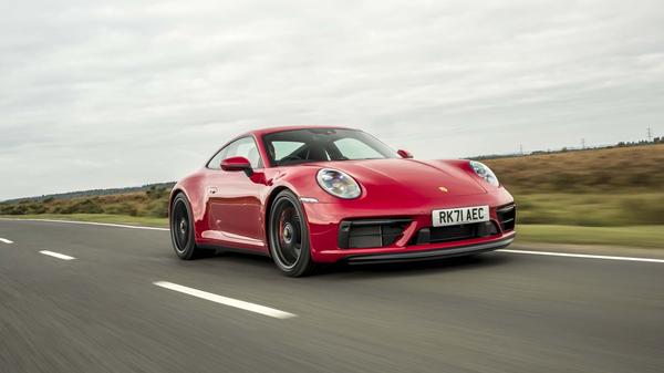 2022 Porsche 911 GTS in red driving on a country road