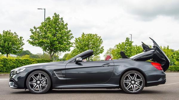 Black Mercedes-Benz SL with roof down