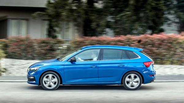 Blue Skoda Scala hatchback driving down a lane