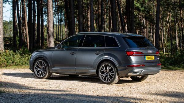 Silver Audi Q7 parked in a forest