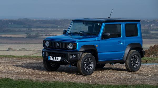 Blue Suzuki Jimny parked on dry grass