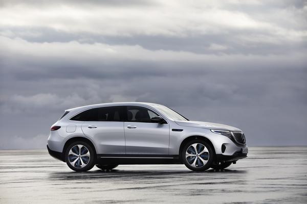 Silver driving over shallow water in a grey coastal region