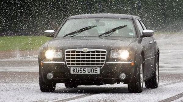 a saloon car driving in snow and winter