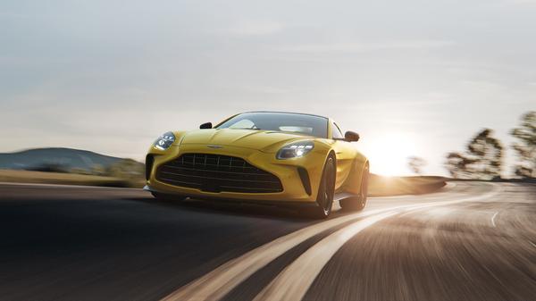 Yellow Aston Martin Vantage driving 