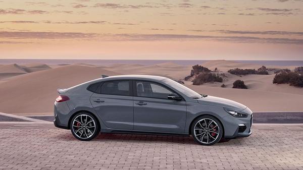Hyundai i30 Fastback N parked near the coast at sunset