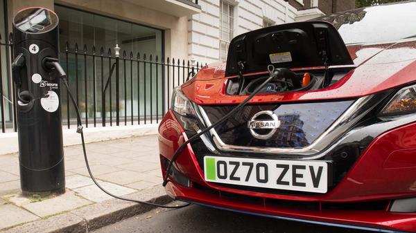Red Nissan Leaf electric car with green number plates