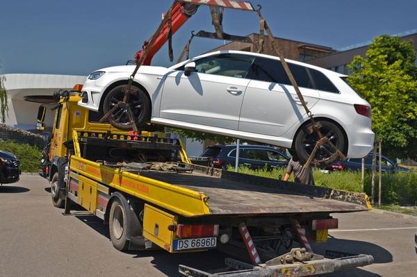 A white car being transported to a local garage covered by European breakdown cover