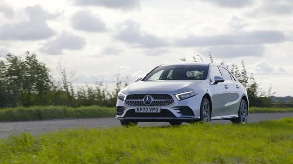 Silver Mercedes A-Class A250e driving round bend