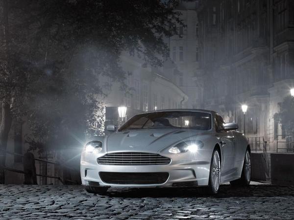 A silver Aston Martin DBS at night time