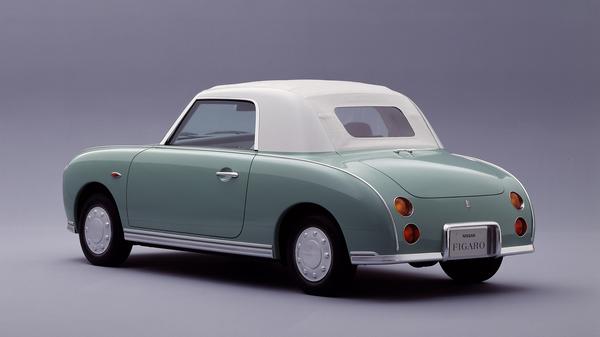 Green and white Nissan Figaro
