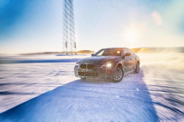 BMW i4 electric car drives through snow