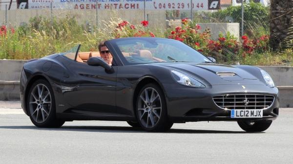 Actor Hugh Grant driving the Ferrari California