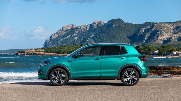 Green Volkswagen T-Cross parked near the sea