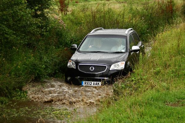 Car driving down flooded country lane