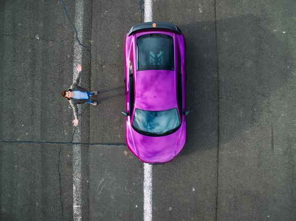 Purple car wrap on the road