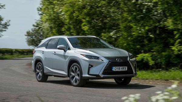 Lexus RX-L driving through a wooded area