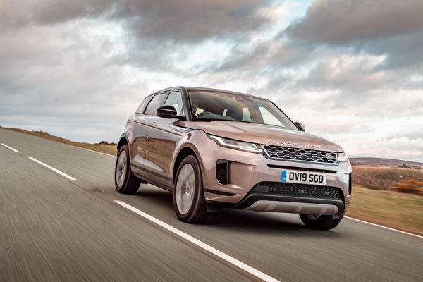 Range Rover Evoque driving over windswept hills