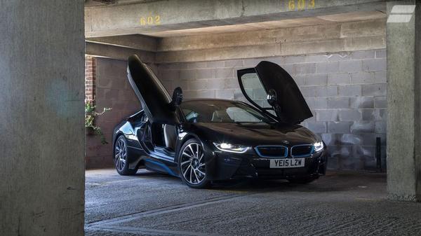 Black BMW i8 in exposed brick car park