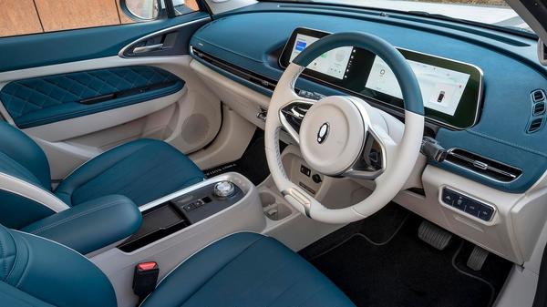 Blue and white interior of an ORA Funky Cat, focusing on the steering wheel