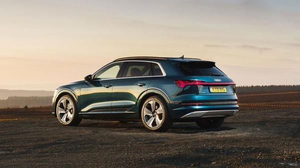 Audi E-Tron parked against a dusky sunset