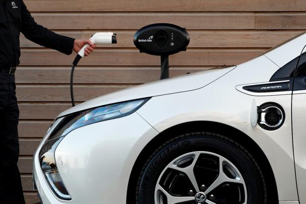 Someone holds an electric car charge cable