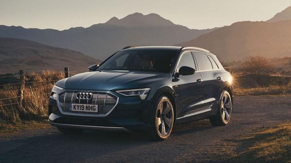 Audi E Tron electric car drives through a canyon