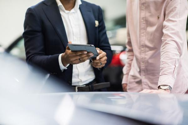 Man getting a vehicle check on a used car