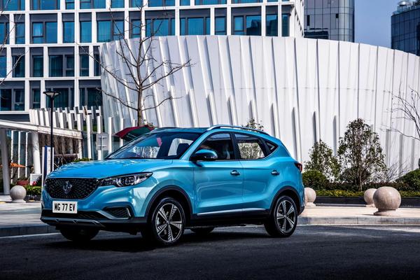Blue MG ZS EV parked in from of modern white building