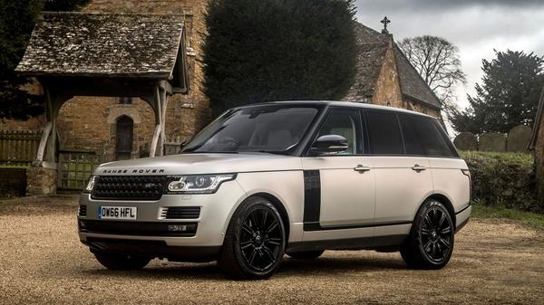 White Range Rover parked in front of an old church