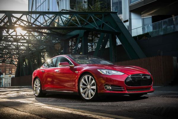 Red Tesla Model S in an industrial complex