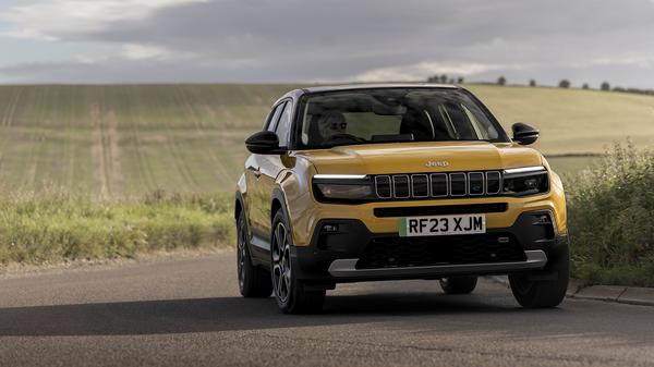 2024 Yellow Jeep Avenger driving on road front