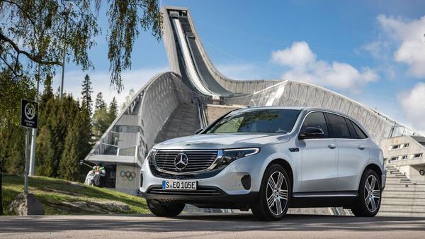 Silver Mercedes-Benz EQC parked in front of a modern building