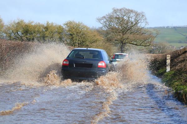 Cars driving through flooded road