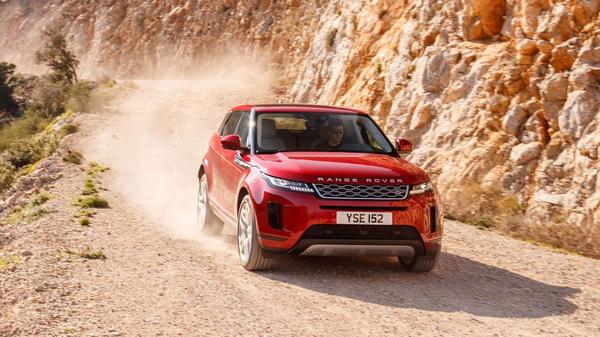 Red Land Rover Range Rover Evoque driving through a canyon