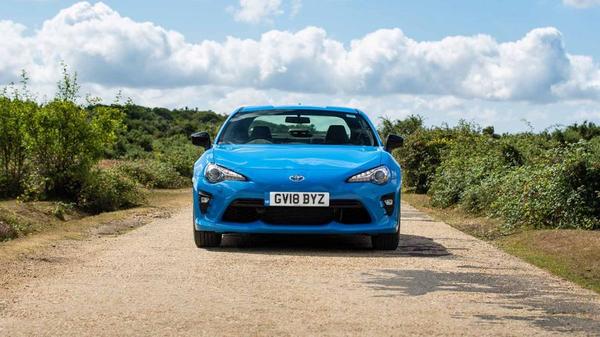 Blue Toyota GT86 on a dusty track 