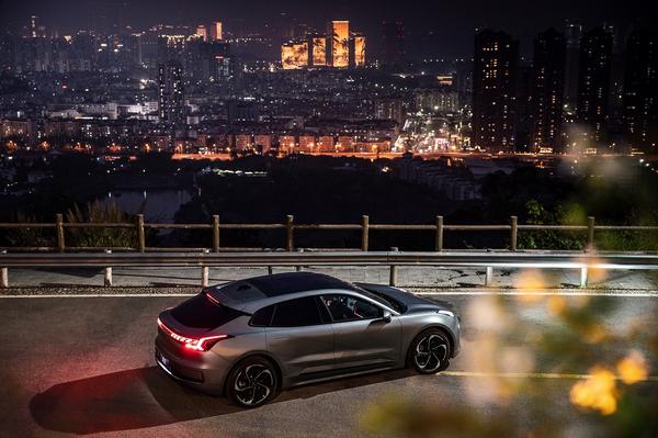 Grey Zeekr 001 electric shooting brake exterior view with city backdrop