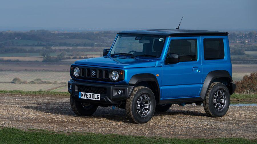 Suzuki Jimny Blue Suzuki Jimny parked on dry grass