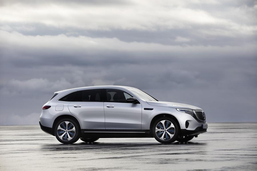 Mercedes EQC Silver driving over shallow water in a grey coastal region
