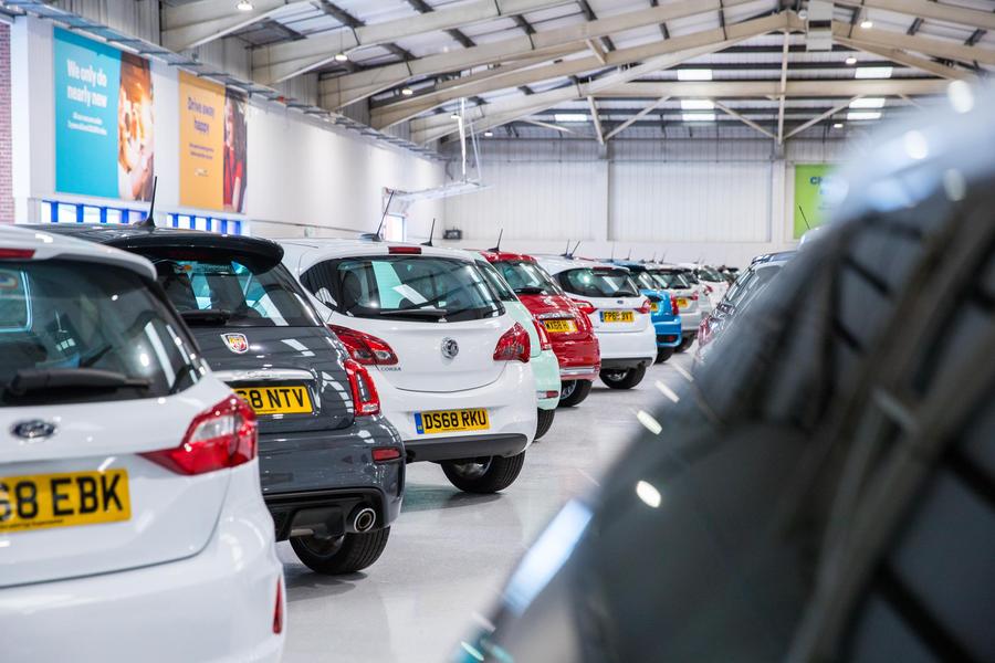 Showrooms can re-open, just make an appointment A car showroom with multiple cars parked inside