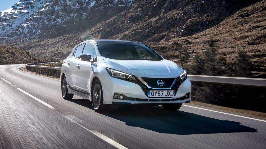 Nissan Leaf White Nissan Leaf driving through mountain range
