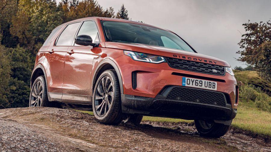 Land Rover Discovery Sport Orange Land Rover Discovery Sport parked on a track