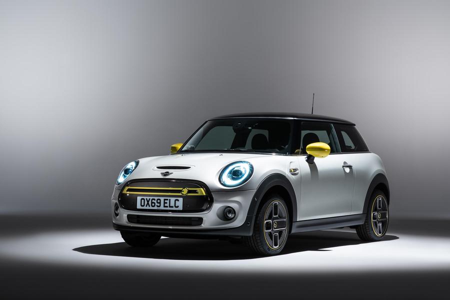Mini Electric White and yellow Mini Electric parked in a showroom