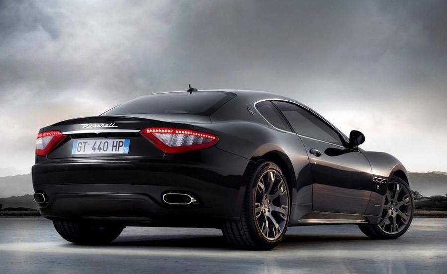 Maserati GranTurismo Rear of black Maserati GranTurismo against stormy sky