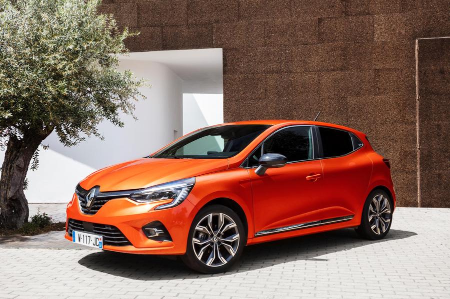 Renault Clio Orange Renault Clio parked in front of a modern house