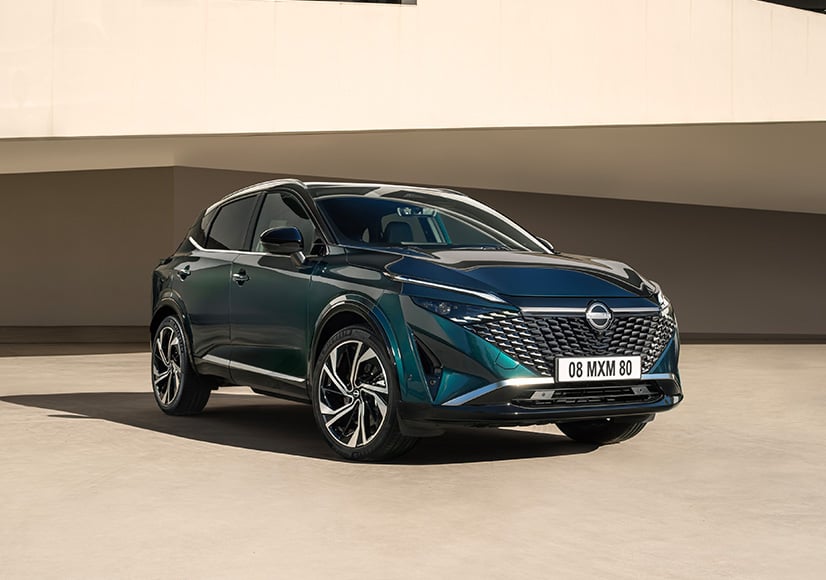 Green Nissan Qashqai front view on drive